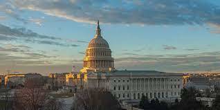 U.S. Capitol building sitting in the horizon at sunrise
