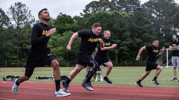 Four men take part in the 100-meter dash during the U.S. Army Trials at Fort Bragg