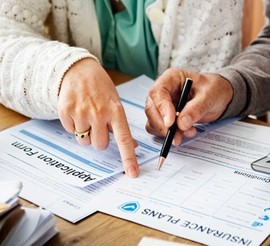 Couple reviews insurance plans
