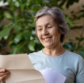 Woman reading letter about VA extending suspension for benefit debts
