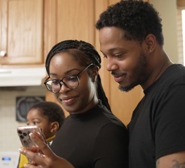 Couple use the GI Bill comparison tool on their phone to compare schools