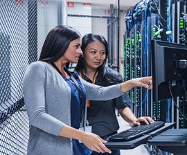 Two women working on computer servers