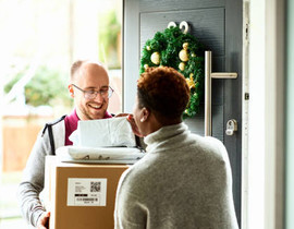 Delivery man handing over packages to woman