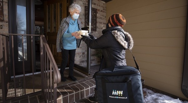 Senior accepting a Meals on Wheels delivery