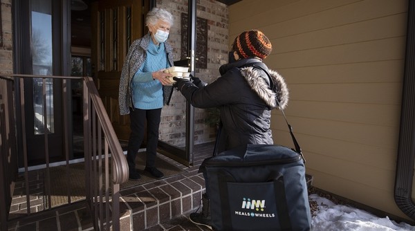 Senior accepting a Meals on Wheels delivery