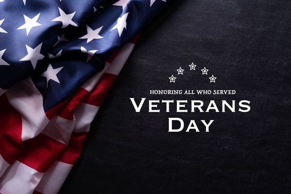 The U.S. flag against a black background with the words: Honoring all who served. Veterans Day