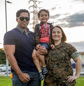 Marine Corps Veteran and service member smiling with their son