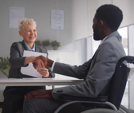 Disabled man at work in his office
