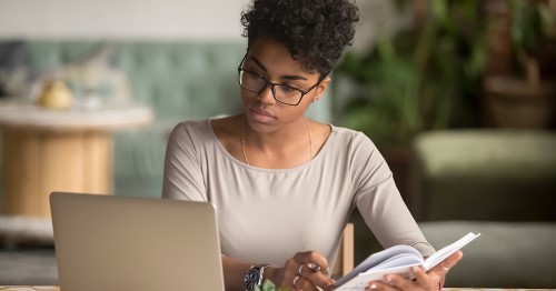 Women sitting working on her laptop