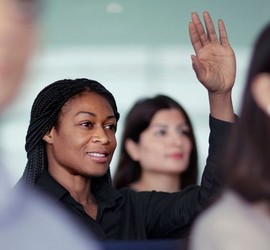 Woman raising her hand in classroom