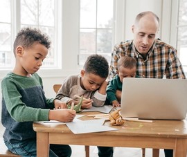 Father reading about his eligibility for VA Survivors Pension benefits on his laptop