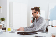 Man in wheelchair at desk