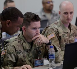Service members reading about TAP and VA benefits on a laptop