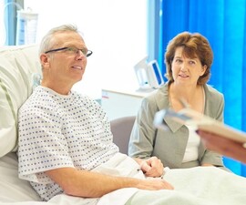 Man speaking with his doctor while recovering from surgery