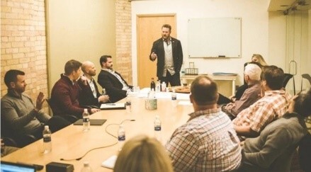 group of men sitting at conference table