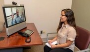 woman sitting at computer on a video call