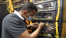 man wearing a mask working with network wires