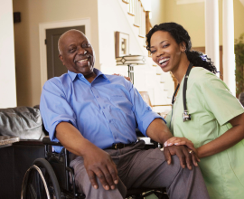 An in home nurse smiles with her elderly african american patient 