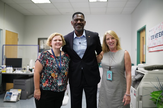 Edward “Ed” Sivells, the millionth enrollment SCO alongside his coworkers