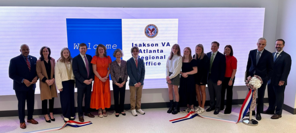 Group of people standing in front of new signage at the Atlanta Regional Office 