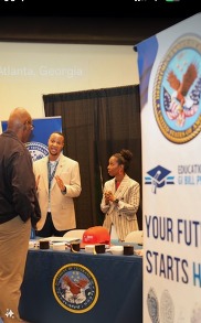 Members of Education Service speak with a MIC attendee.