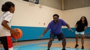 Man playing basketball with his children