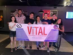 Image of group holding a VITAL sign