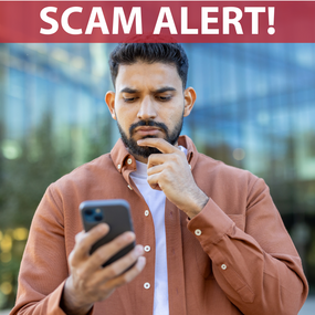 man looks at smartphone with concern