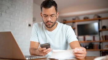Male studying home documents