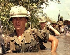 Soldiers going through the swamp with weapons