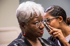 A Veteran having her ears checked at VA medical center