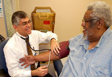 Doctor takes Veteran's blood pressure