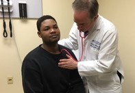 Veteran having a chest exam 