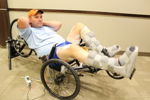 Paralyzed Veteran using surface stimulation on his legs to pedal a trike