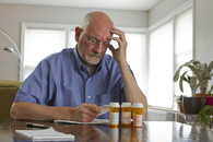 A Veteran looking over his medication