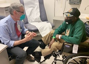 A Veteran and his doctor at a VA medical center wearing masks