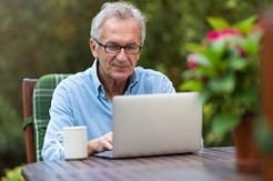 A Veteran using Secure Messaging in his backyard