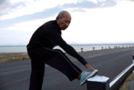 A Veteran stretching during his run