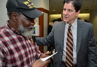 A Veteran speaking with someone at his local VA