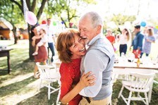 A Veteran and his partner dancing in their backyard