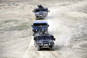 military vehicles driving in desert