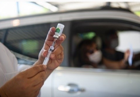 A Veteran receiving a vaccination at a VA medical center drive up clinic