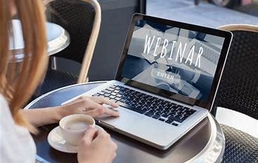 person with hand on laptop and cup of coffee