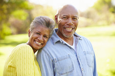 Elderly black spouses sharing a smile