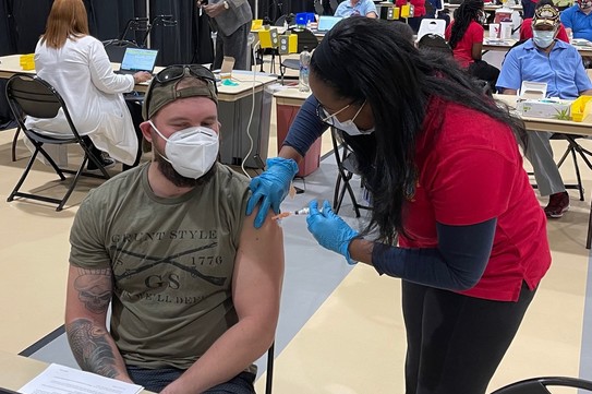 Young Veteran getting vaccine