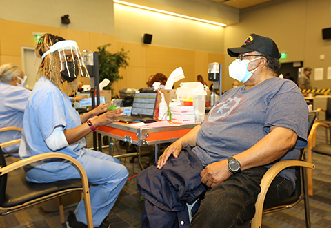 A VA nurse talks with a Veteran