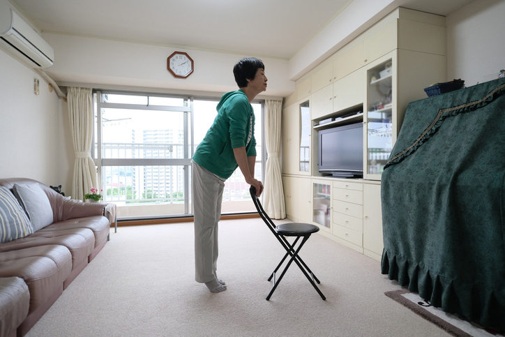 A Veteran doing exercises behind a folding chair