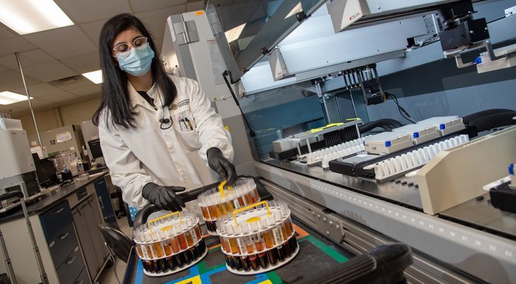 A laboratory worker with research materials