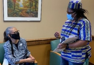 A Veteran talking to a health care worker at her local VA facility  