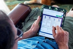 A Veteran using his tablet to review his records on My HealtheVet
